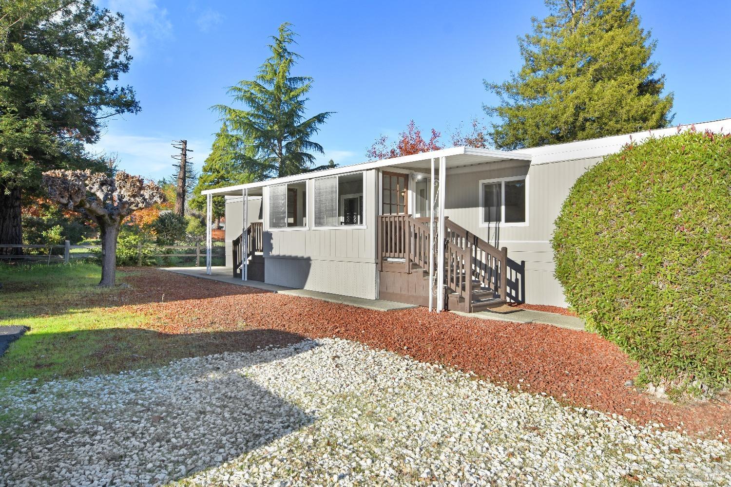 Side view of enclosed porch and open green space