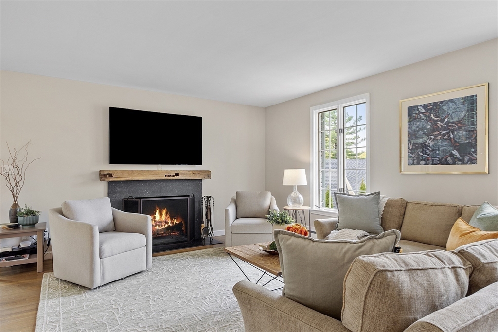 3 B Pelham Road Lexington, MA 02421 - Photo 11 of 41 a living room with furniture a fireplace and a flat screen tv