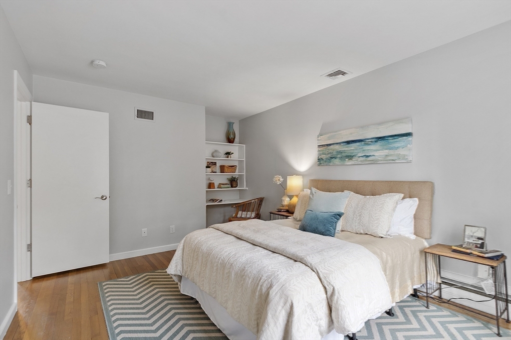 3 B Pelham Road Lexington, MA 02421 - Photo 22 of 41 a bedroom with a bed and a painting on the wall