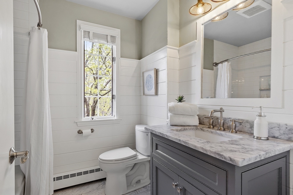 3 B Pelham Road Lexington, MA 02421 - Photo 23 of 41 a bathroom with a granite countertop sink toilet and mirror