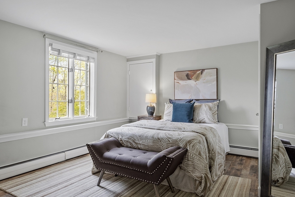 3 B Pelham Road Lexington, MA 02421 - Photo 26 of 41 a bedroom with a bed and wooden floor