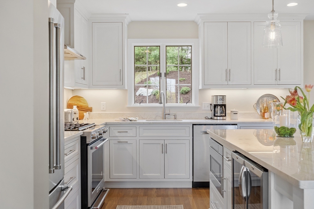3 B Pelham Road Lexington, MA 02421 - Photo 5 of 41 a kitchen with stainless steel appliances granite countertop a sink stove and cabinets