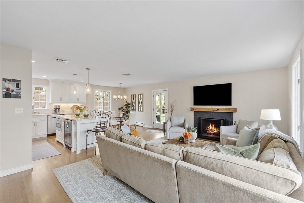 3 B Pelham Road Lexington, MA 02421 - Photo 9 of 41 a living room with furniture a fireplace and a flat screen tv