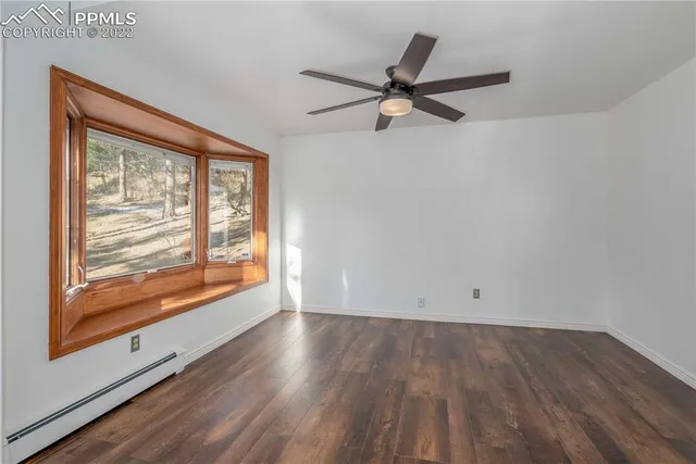 a bathroom with a granite countertop shower mirror and a toilet
