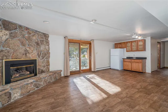 a view of a room with wooden floor and cabinet