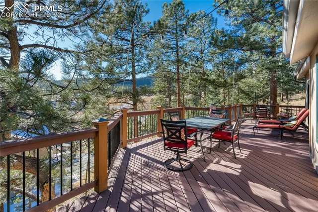 a view of a dinning table and chairs on the roof deck