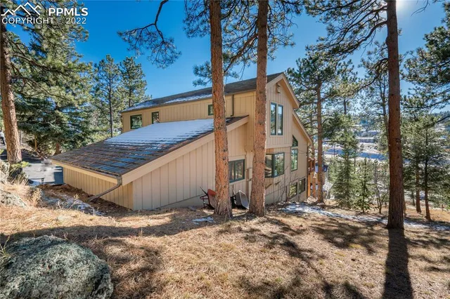 a view of backyard with outdoor seating and trees