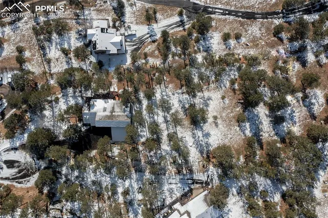 a bird view of a house with a yard and tree s