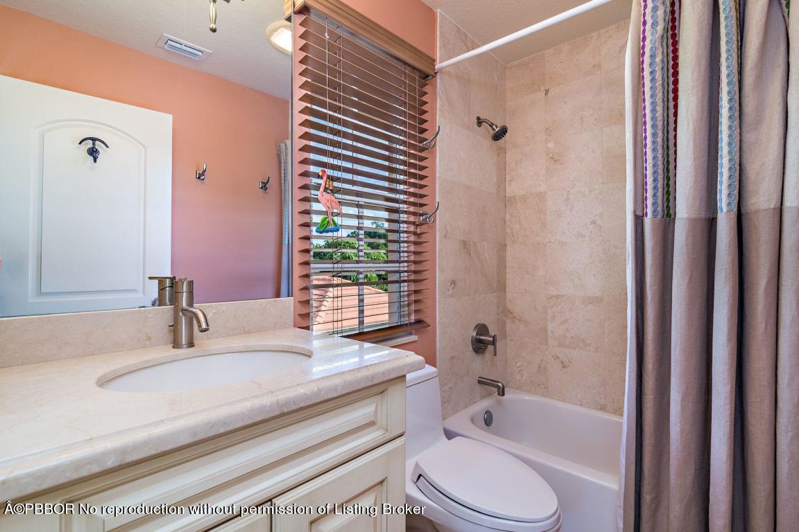 309 Valencia Road West Palm Beach, FL 33401 - Photo 15 of 24 a bathroom with a granite countertop sink toilet and shower