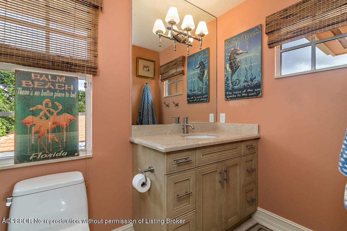 309 Valencia Road West Palm Beach, FL 33401 - Photo 17 of 24 a bathroom with a sink a vanity and a mirror