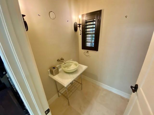 309 Valencia Road West Palm Beach, FL 33401 - Photo 7 of 24 a bathroom with a sink toilet and a mirror