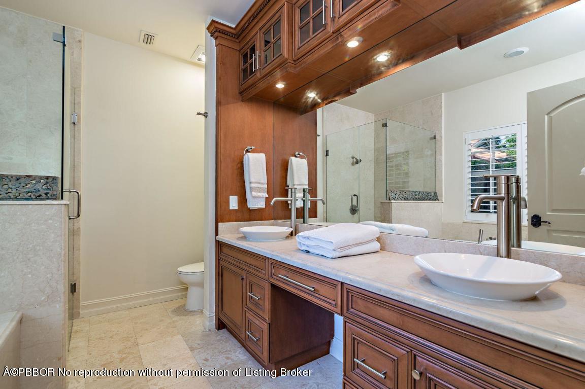 309 Valencia Road West Palm Beach, FL 33401 - Photo 9 of 24 a bathroom with a granite countertop sink a toilet and a mirror