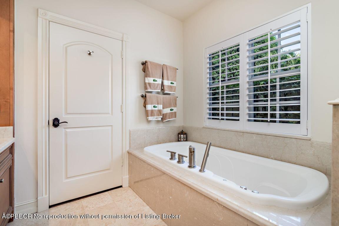 309 Valencia Road West Palm Beach, FL 33401 - Photo 10 of 24 a white bath tub sitting next to a window