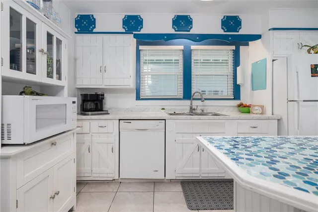 a kitchen with cabinets appliances and a counter space