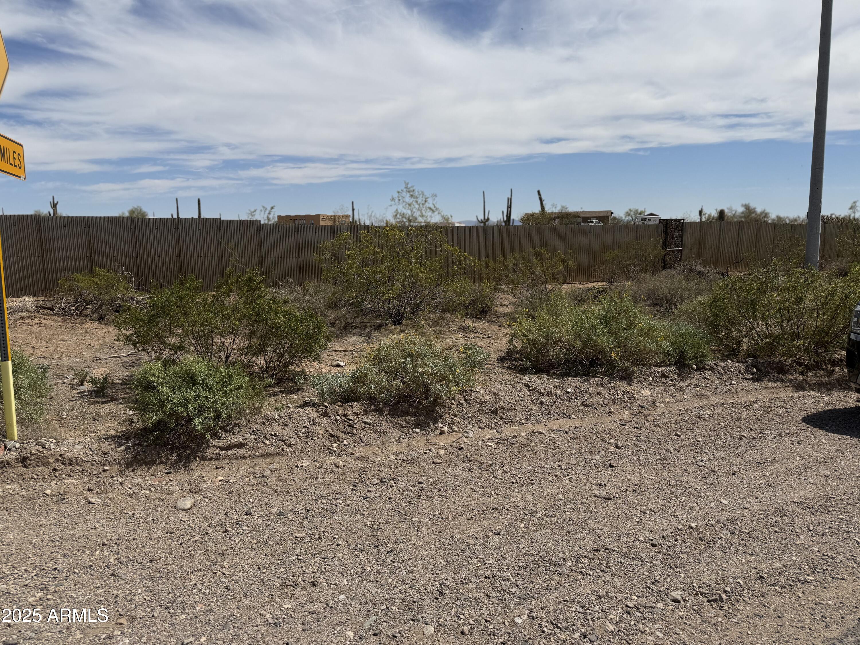 Xx00 North Castle Hot Springs Road Morristown, AZ 85342 - Photo 3 of 10 a view of a dry yard with wooden fence