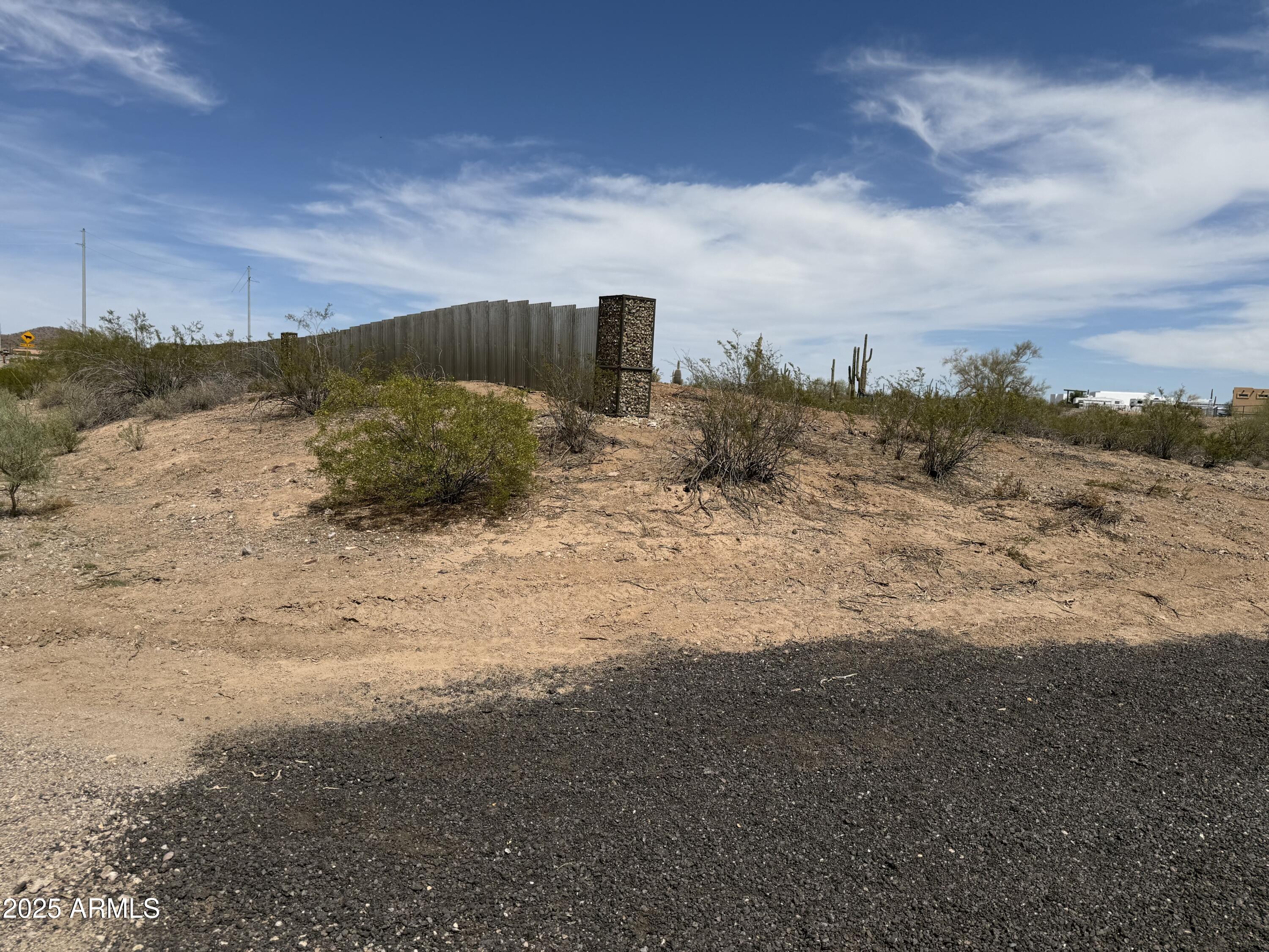 Xx00 North Castle Hot Springs Road Morristown, AZ 85342 - Photo 5 of 10 a view of a dry yard with wooden fence
