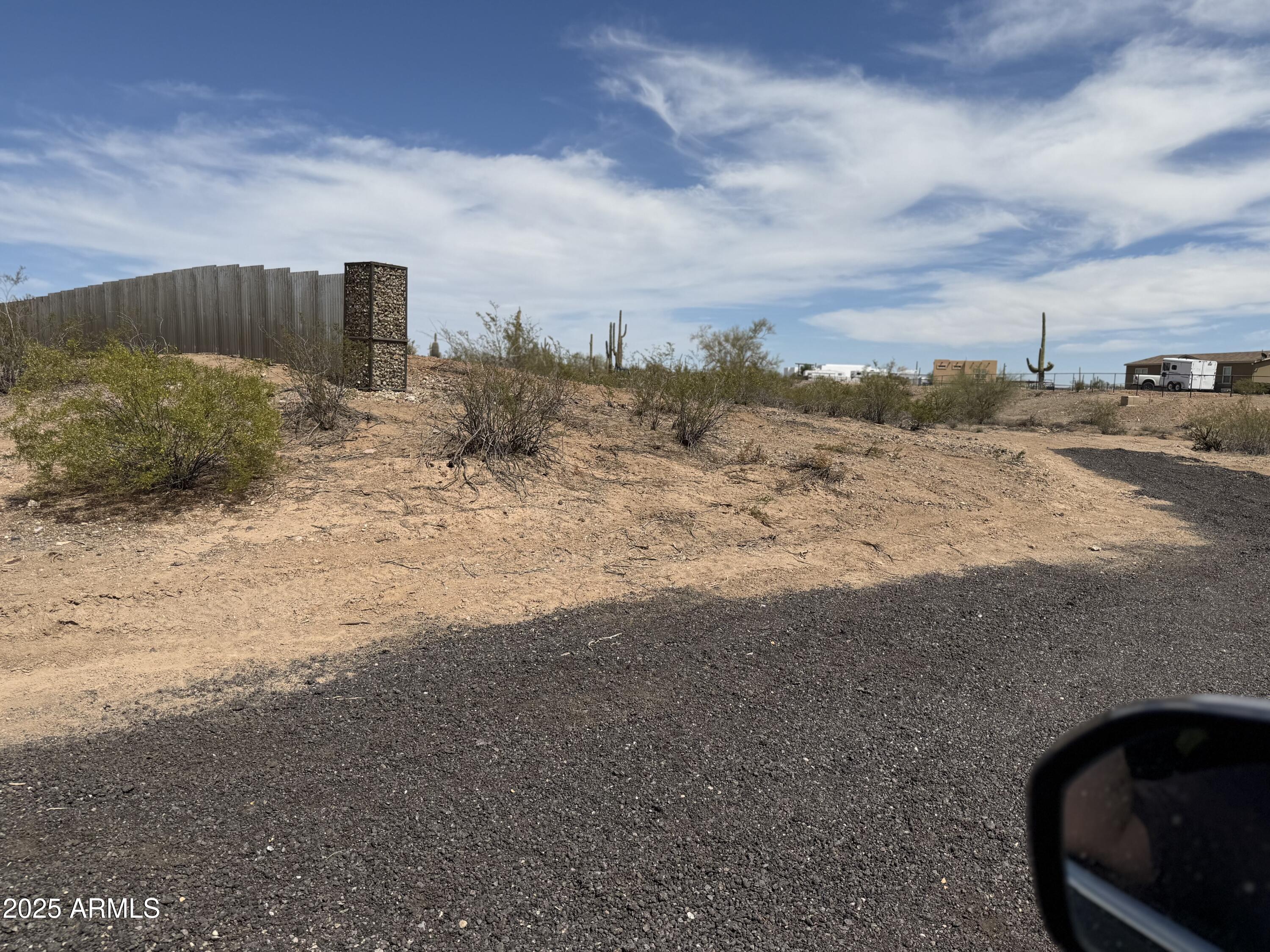 Xx00 North Castle Hot Springs Road Morristown, AZ 85342 - Photo 8 of 10 a view of a dry yard with wooden fence