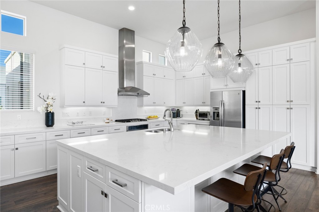 134 Stellar Irvine, CA 92618 - Photo 11 of 49 a kitchen with kitchen island a stove a table a sink and cabinets