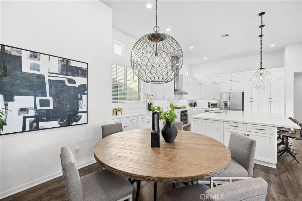 134 Stellar Irvine, CA 92618 - Photo 14 of 49 a dining room filled chandelier and wooden floor