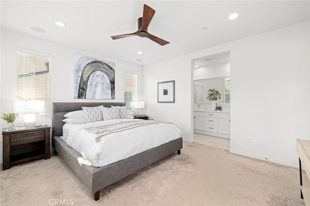 134 Stellar Irvine, CA 92618 - Photo 16 of 49 a spacious bedroom with a bed a window and potted plant