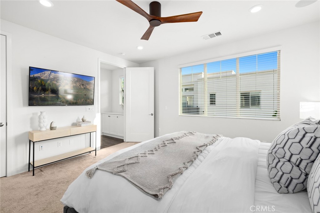134 Stellar Irvine, CA 92618 - Photo 17 of 49 a bedroom with a bed and a flat screen tv