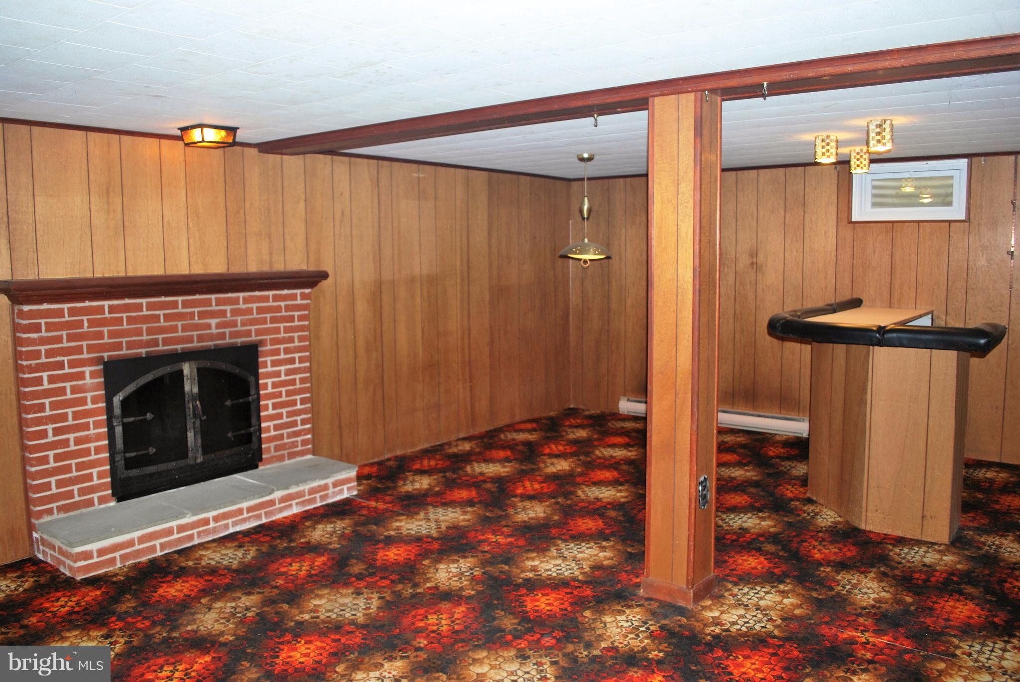 49 Harmony Hall Road Gaithersburg, MD 20877 - Photo 24 of 26 Family room with fireplace and bar.