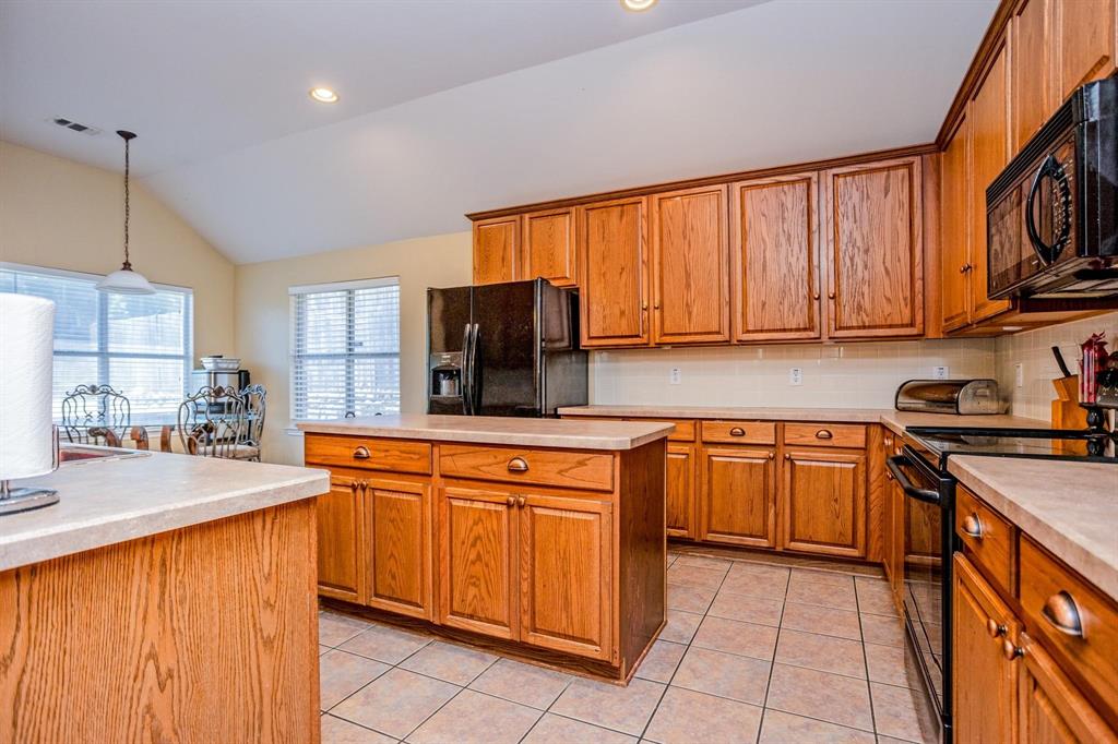 a kitchen with stainless steel appliances granite countertop wooden cabinets a stove top oven a sink and dishwasher
