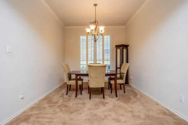 a bedroom with a bed a lamp and a large window