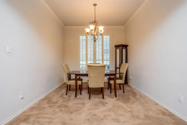 a bedroom with a bed a lamp and a large window