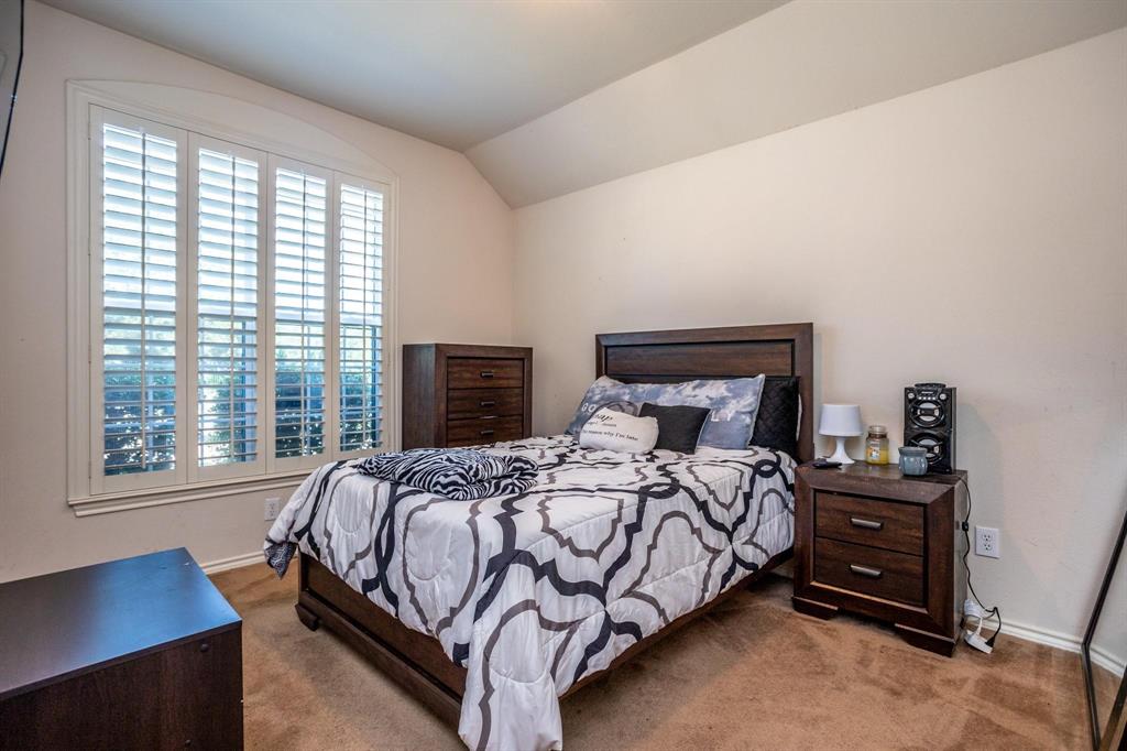 5886 Cliff Ridge Drive Dallas, TX 75249 - Photo 12 of 15 a bedroom with a bed a lamp and a large window
