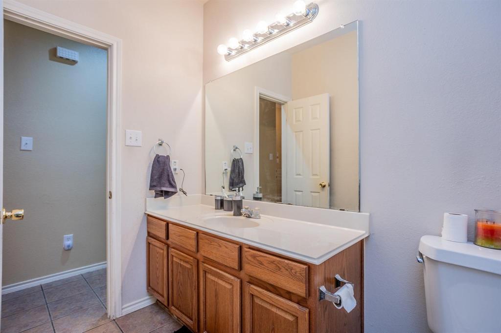 5886 Cliff Ridge Drive Dallas, TX 75249 - Photo 7 of 15 a bathroom with a sink and a mirror