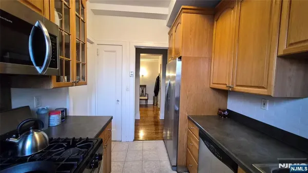 a kitchen with stainless steel appliances a stove a refrigerator and cabinets