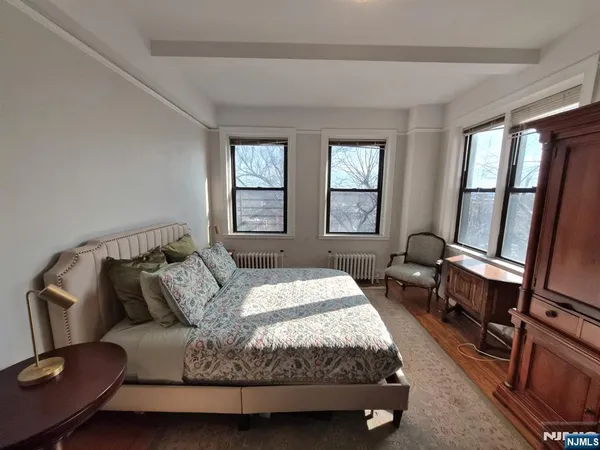 a bed sitting in a bedroom next to a window