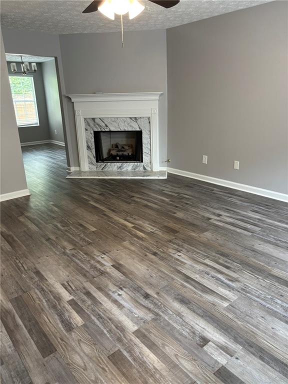 5739 Windfall Lane Lithonia, GA 30058 - Photo 9 of 36 an empty room with wooden floor fireplace and window
