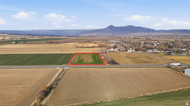 5601 West 15200 North Riverside, UT 84334 - Photo 5 of 10 Aerial view of sparsely populated area featuring property boundaries highlighted, abundant farmland, and a mountain backdrop