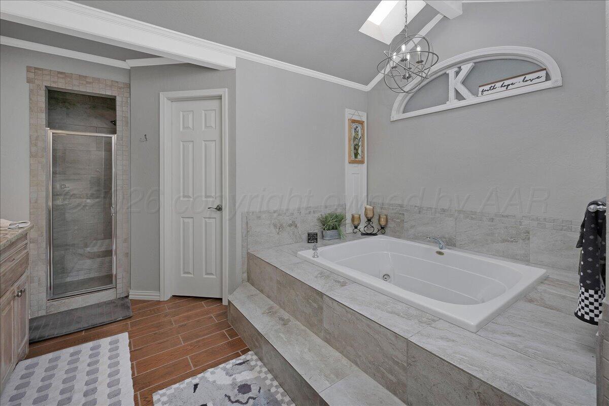 5 Locke Place Amarillo, TX 79124 - Photo 22 of 53 a bathroom with a tub a double vanity sink and shower