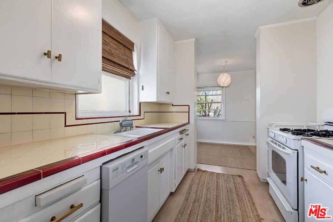223 6th Avenue Venice, CA 90291 - Photo 11 of 39 a kitchen with a sink stove and cabinets