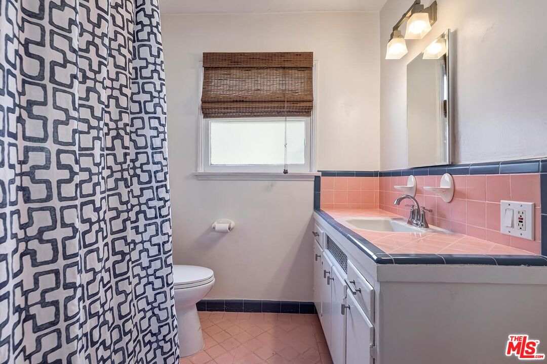 223 6th Avenue Venice, CA 90291 - Photo 15 of 39 a bathroom with a sink a toilet and a mirror