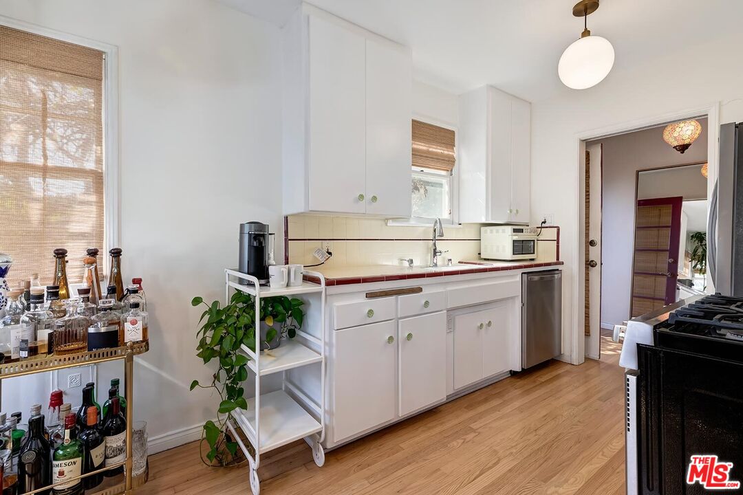 223 6th Avenue Venice, CA 90291 - Photo 21 of 39 a kitchen with a sink stove and cabinets