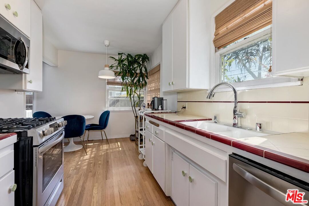 223 6th Avenue Venice, CA 90291 - Photo 23 of 39 a kitchen with a sink stove and microwave