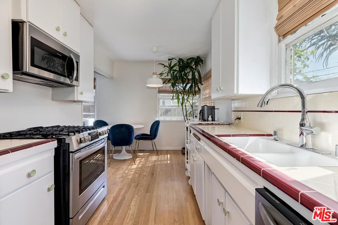 223 6th Avenue Venice, CA 90291 - Photo 24 of 39 a kitchen with a sink stove and microwave