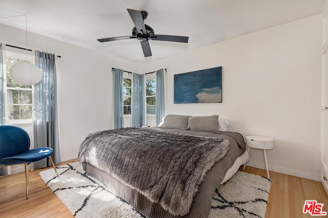 223 6th Avenue Venice, CA 90291 - Photo 25 of 39 a bedroom with a bed mirror and a window