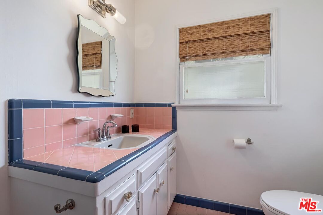 223 6th Avenue Venice, CA 90291 - Photo 27 of 39 a bathroom with a sink and a mirror