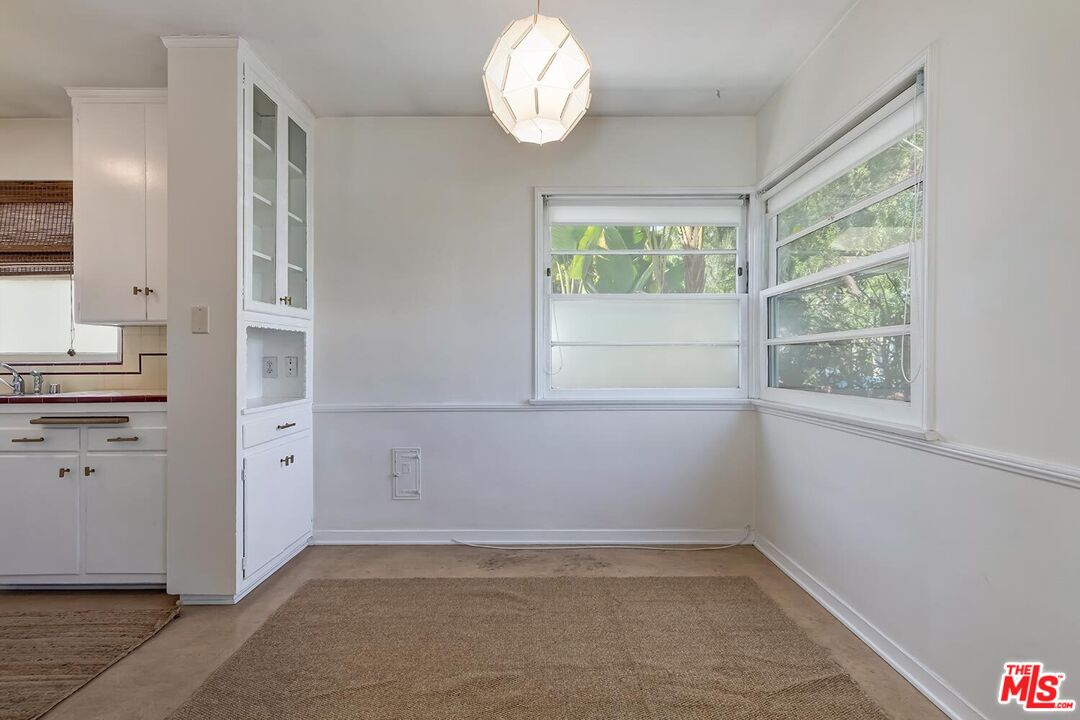 223 6th Avenue Venice, CA 90291 - Photo 37 of 39 a view of a kitchen with white cabinets and wooden floor