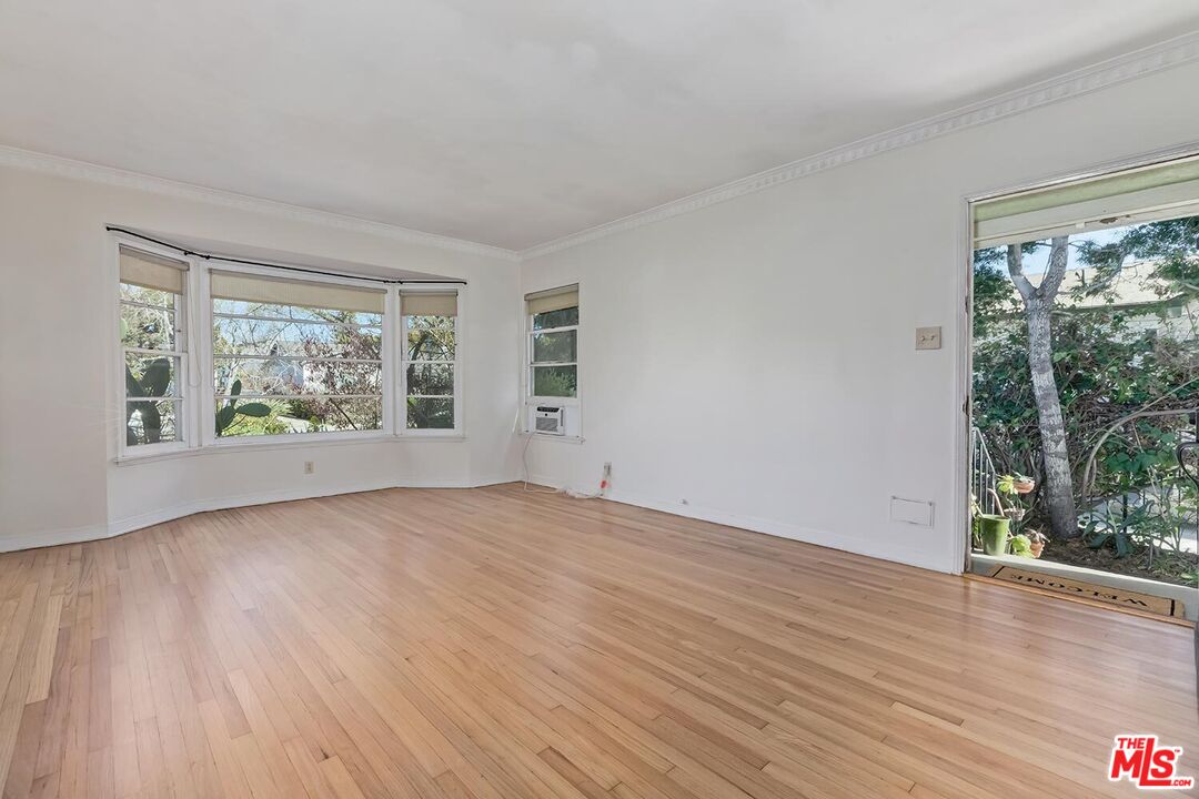 223 6th Avenue Venice, CA 90291 - Photo 8 of 39 a view of an empty room with wooden floor and a window