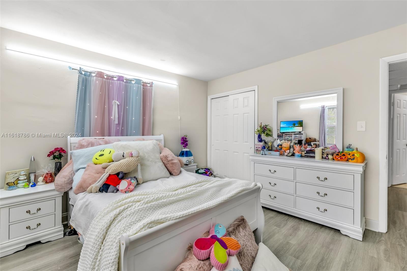 243 Southwest 9th Street Dania Beach, FL 33004 - Photo 15 of 31 a bedroom with a bed and a dresser