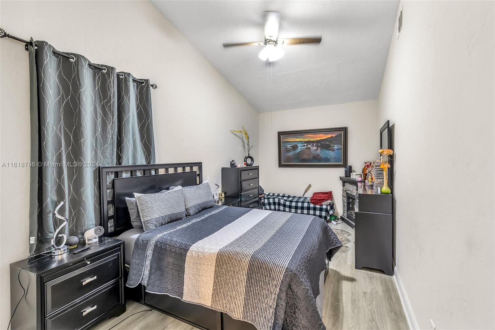 243 Southwest 9th Street Dania Beach, FL 33004 - Photo 18 of 31 a bedroom with a bed and a chandelier