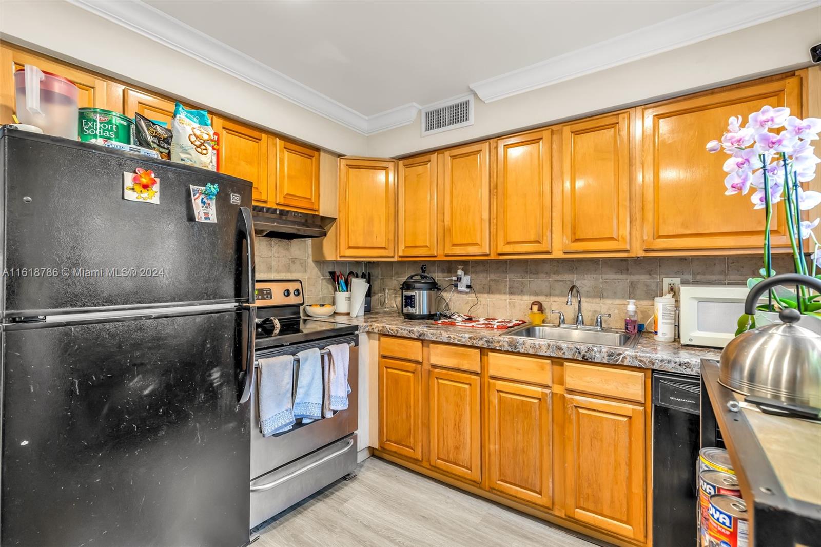 243 Southwest 9th Street Dania Beach, FL 33004 - Photo 22 of 31 a kitchen with stainless steel appliances granite countertop a refrigerator a sink and a stove