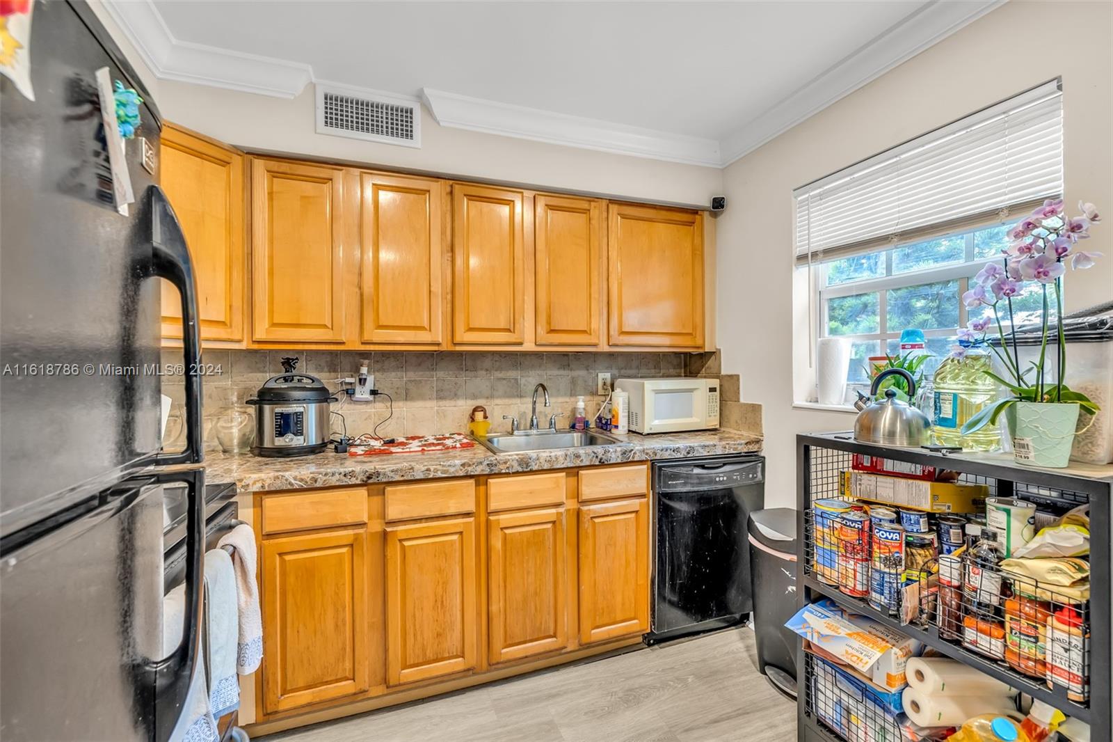 243 Southwest 9th Street Dania Beach, FL 33004 - Photo 23 of 31 a kitchen with stainless steel appliances granite countertop a refrigerator and a stove