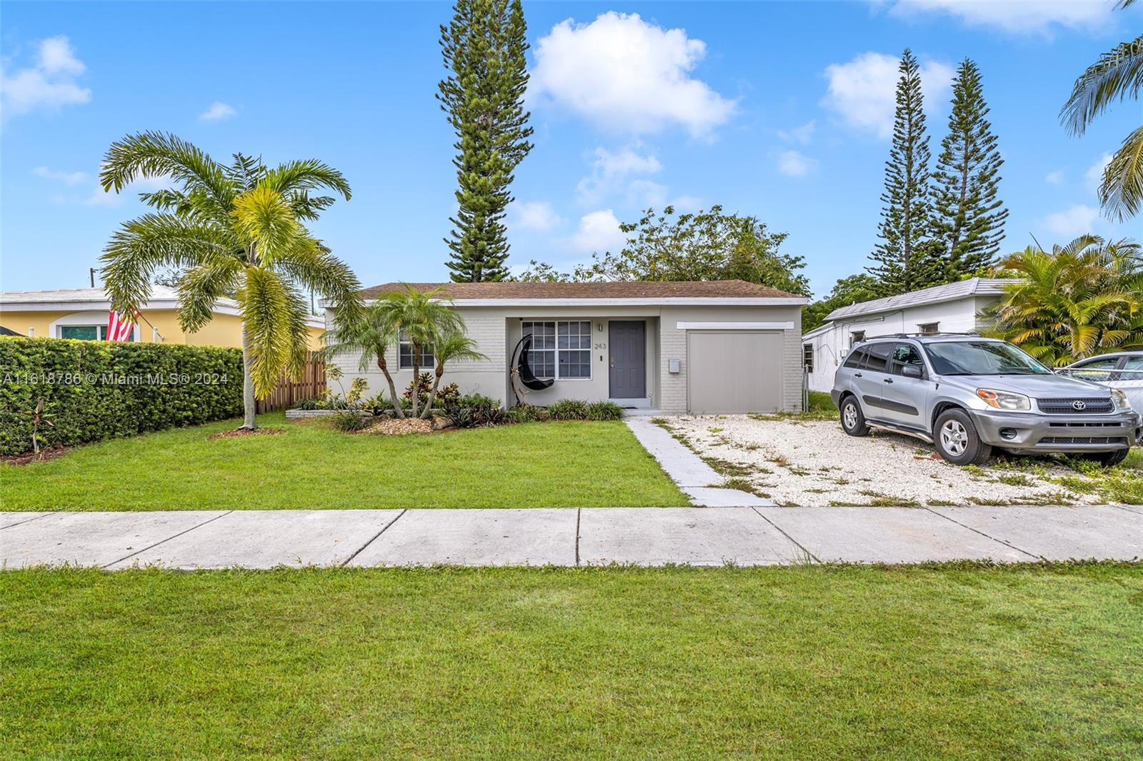 243 Southwest 9th Street Dania Beach, FL 33004 - Photo 6 of 31 a front view of a house with a yard and fountain